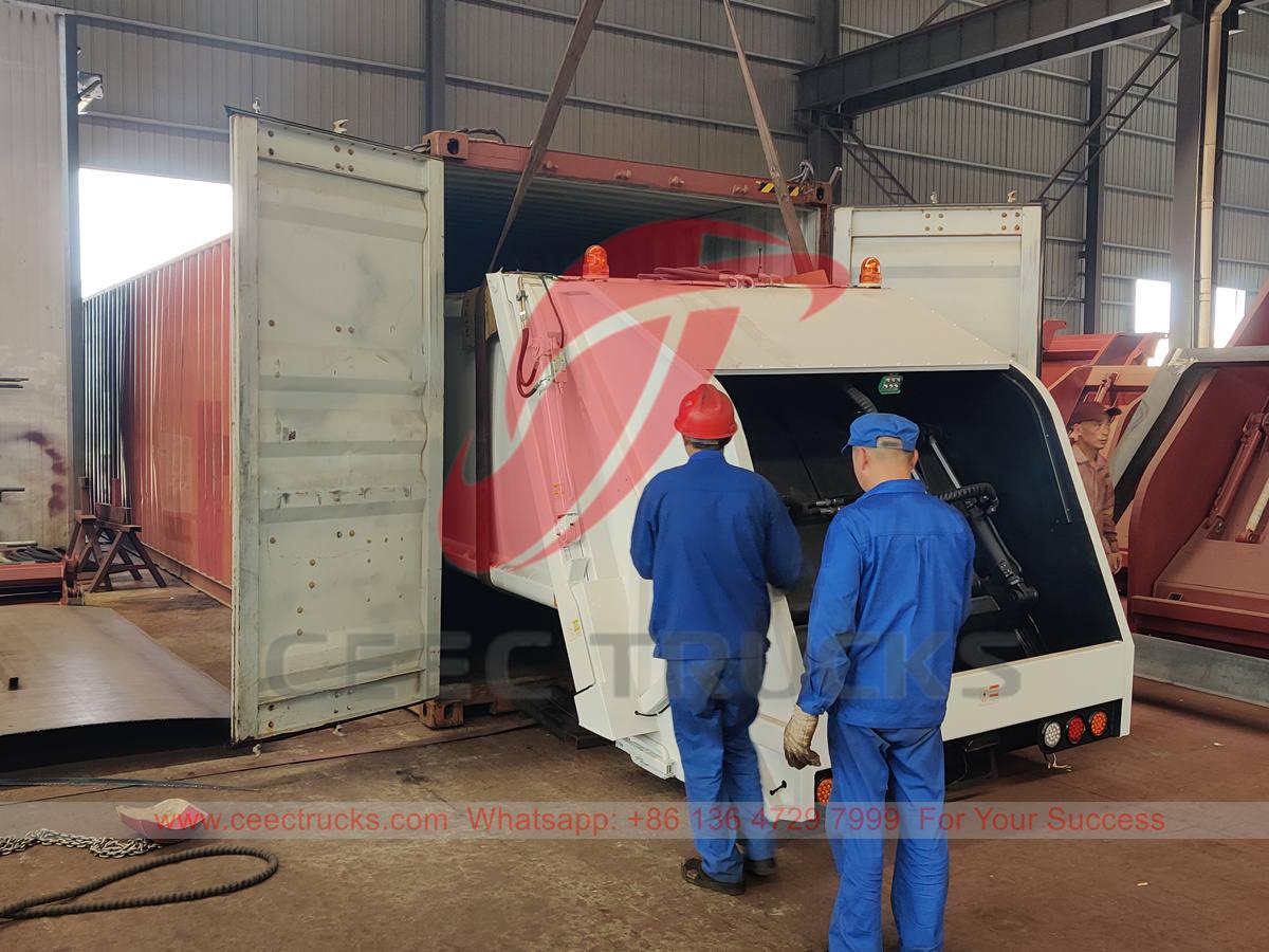 Garbage compactor upper body loaded in container